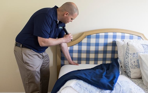 Man inspections the bed