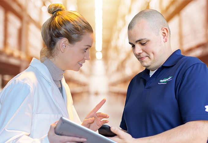 Pest control technician showing information to a homeowner