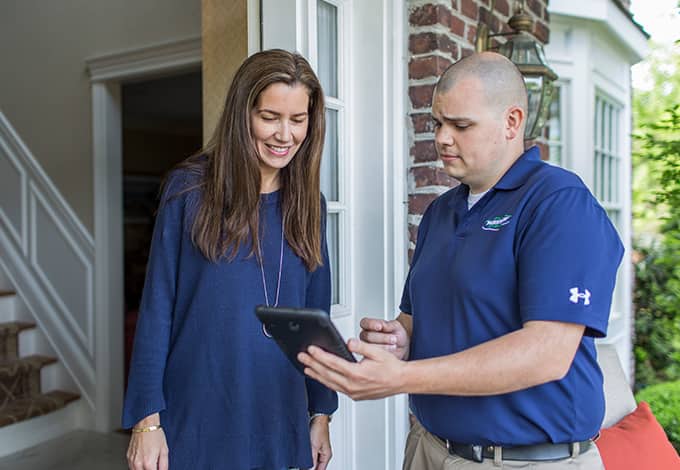 Homeowner and pest control technician talking