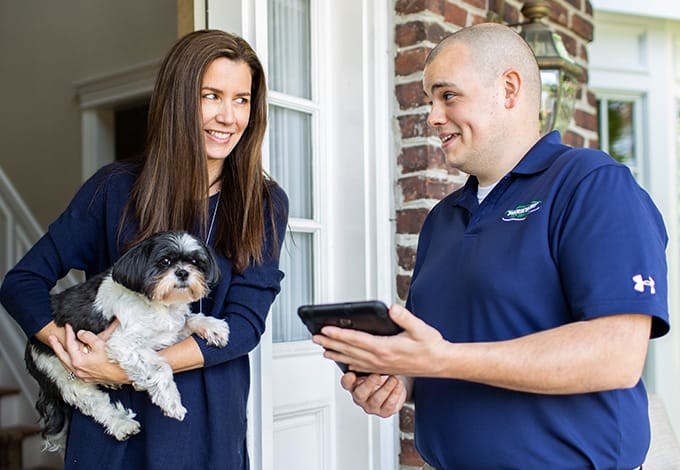 Homeowner and pest control technician talking